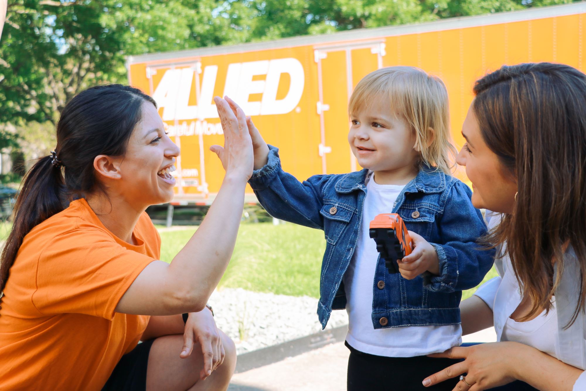Child high-fiving Allied mover